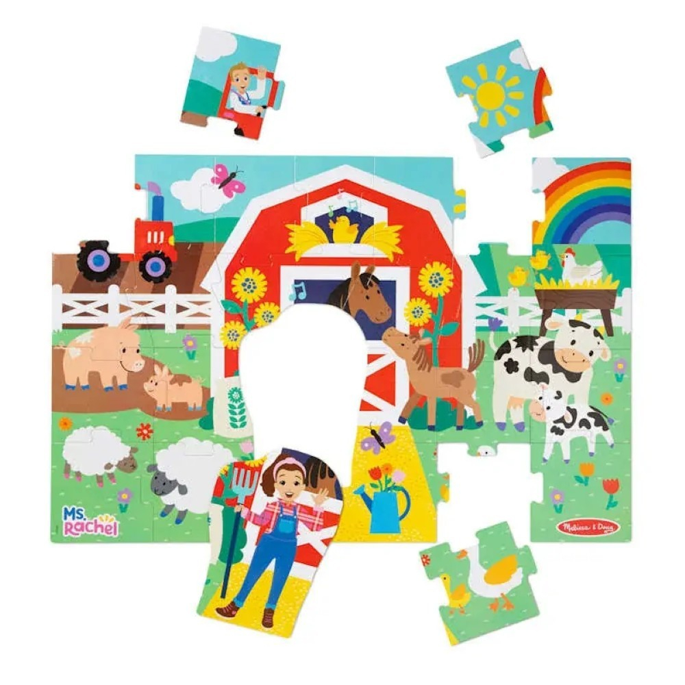 0000772504164-2 Melissa & Doug Ms. Rachel Floor Puzzle Farm Ms Rachel is a colorful farm-themed jigsaw puzzle featuring a barn, animals, a rainbow, and a person holding a pitchfork, with some pieces missing.