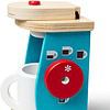 A Melissa & Doug Brew and Serve Wooden Coffee Maker Set with a mug on it.