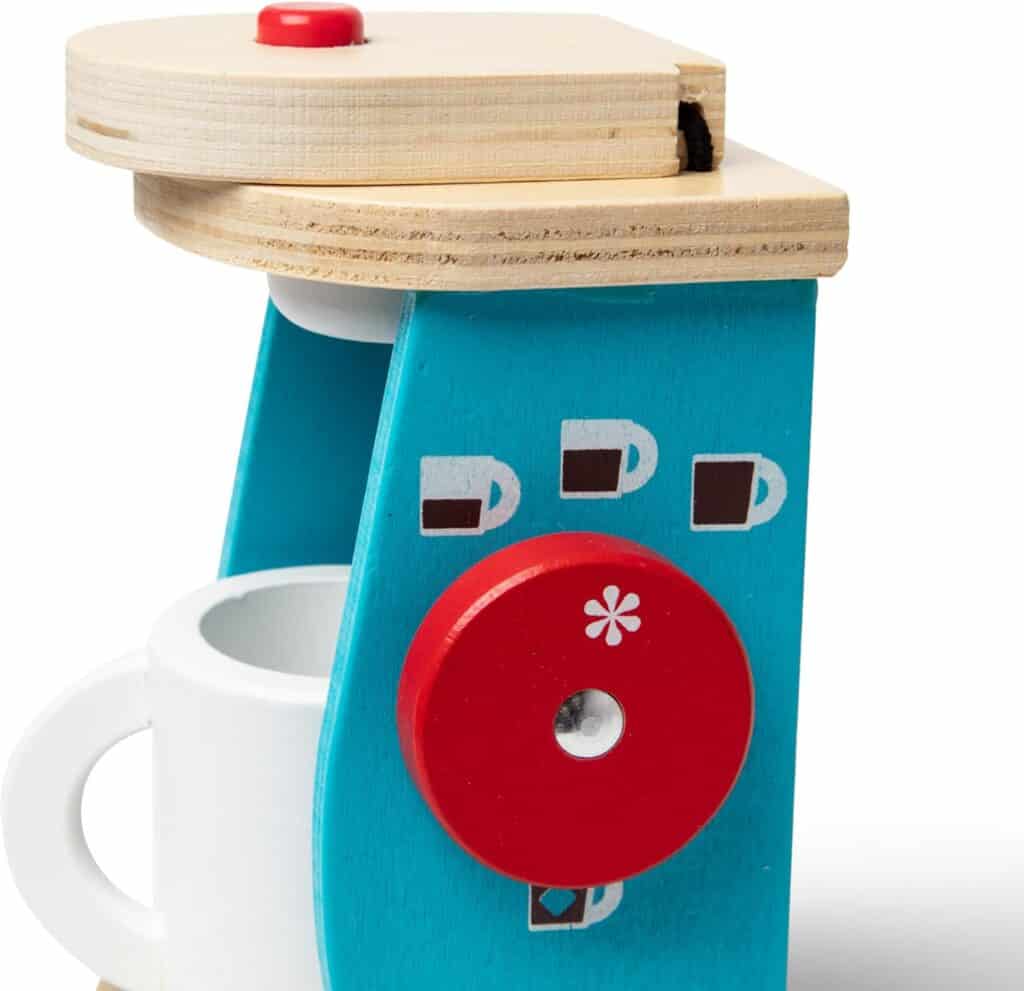 A Melissa & Doug Brew and Serve Wooden Coffee Maker Set with a mug on it.