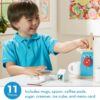 A young boy is playing with the Melissa & Doug Brew and Serve Wooden Coffee Maker Set.