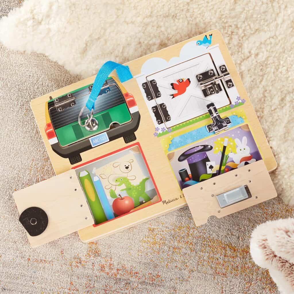 A Melissa & Doug Locks and Latches Board with a teddy bear on it.