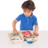 A young boy playing with the Melissa & Doug Locks and Latches Board.