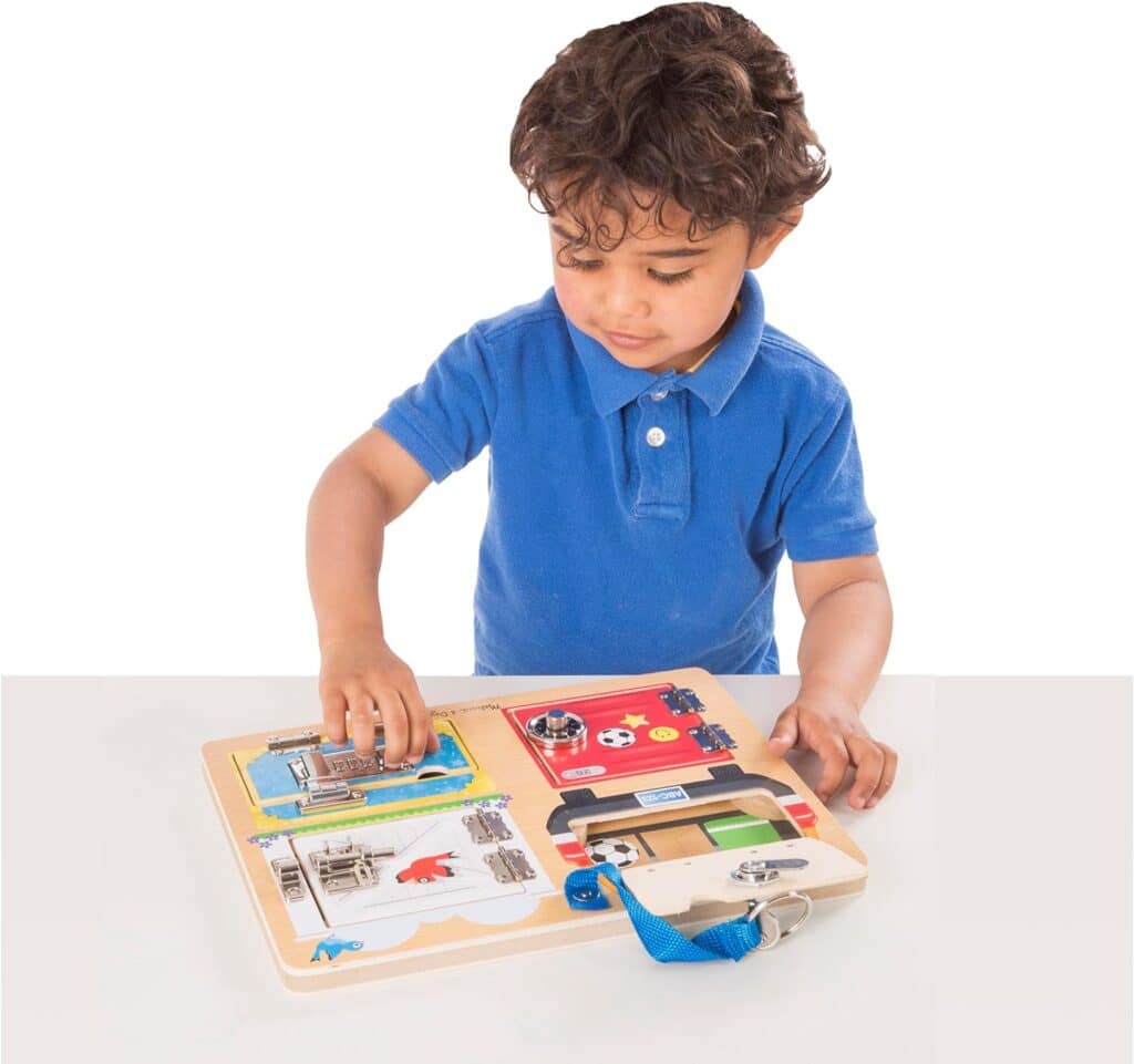 A young boy playing with the Melissa & Doug Locks and Latches Board.