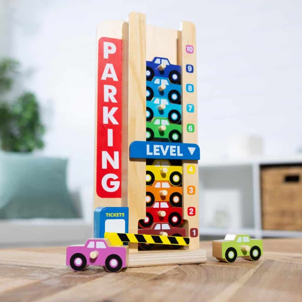 A Melissa & Doug Stack & Count Wooden Parking Garage with 10 Cars toy.