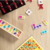 A set of Melissa & Doug Dominoes Tabletop Game 28 Colorful Tiles on a wooden table.