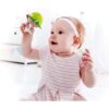 A baby is playing with the Hape Put-Stay Sea Animal Suction Rattle Set Three Toys.