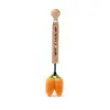 A wooden spoon with Oli & Carol Cathy the Carrot Mini Doudou Teether Natural Rubber on it.