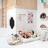 A child's playroom with a wooden floor and white walls.