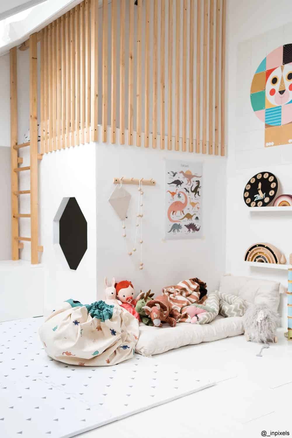 A child's playroom with a wooden floor and white walls.