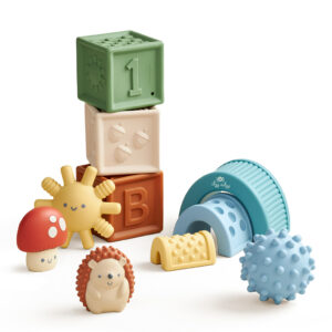 Itzy Ritzy Sensory Blocks 10-Piece Set with numbers and letters, accompanied by colorful textured toys like a sun, mushroom, hedgehog, and balls on a white background.