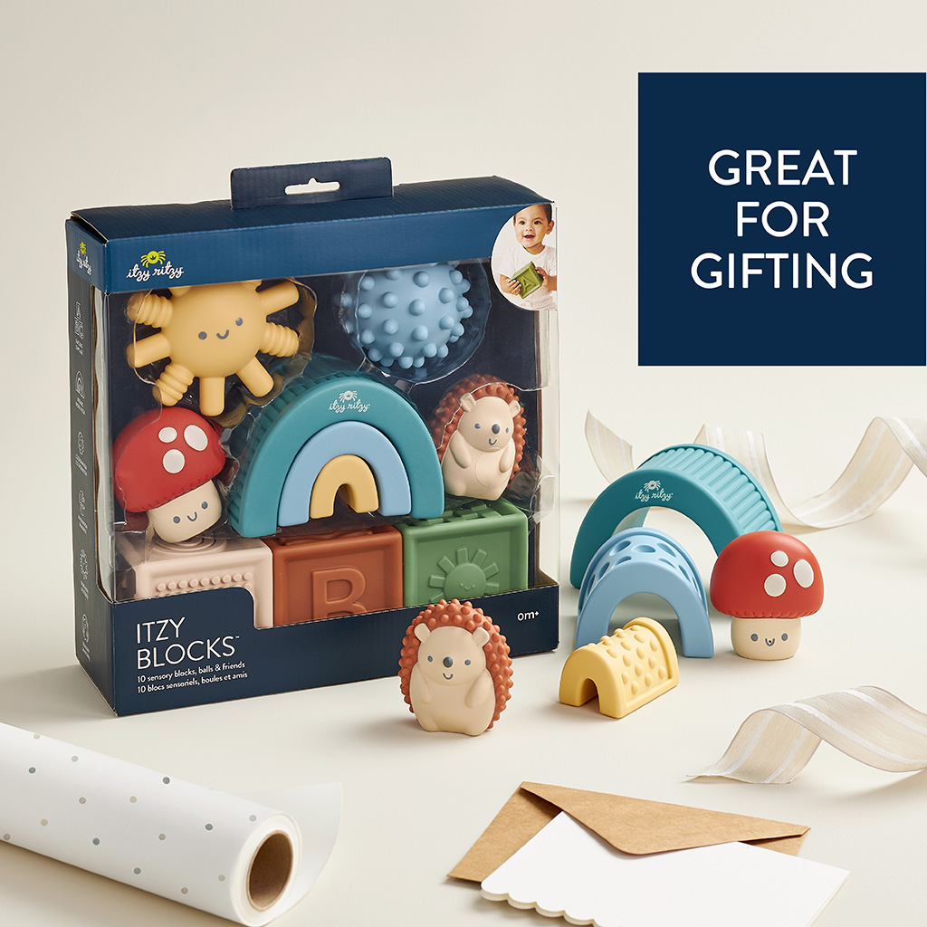BL853201_Itzy_Ritzy_Toy_Itzy_Blocks_DigitalShelf Baby toy set featuring Itzy Ritzy Sensory Blocks 10-Piece Set and teething toys, packaged in a clear box labeled "great for gifting," with decorative elements around.