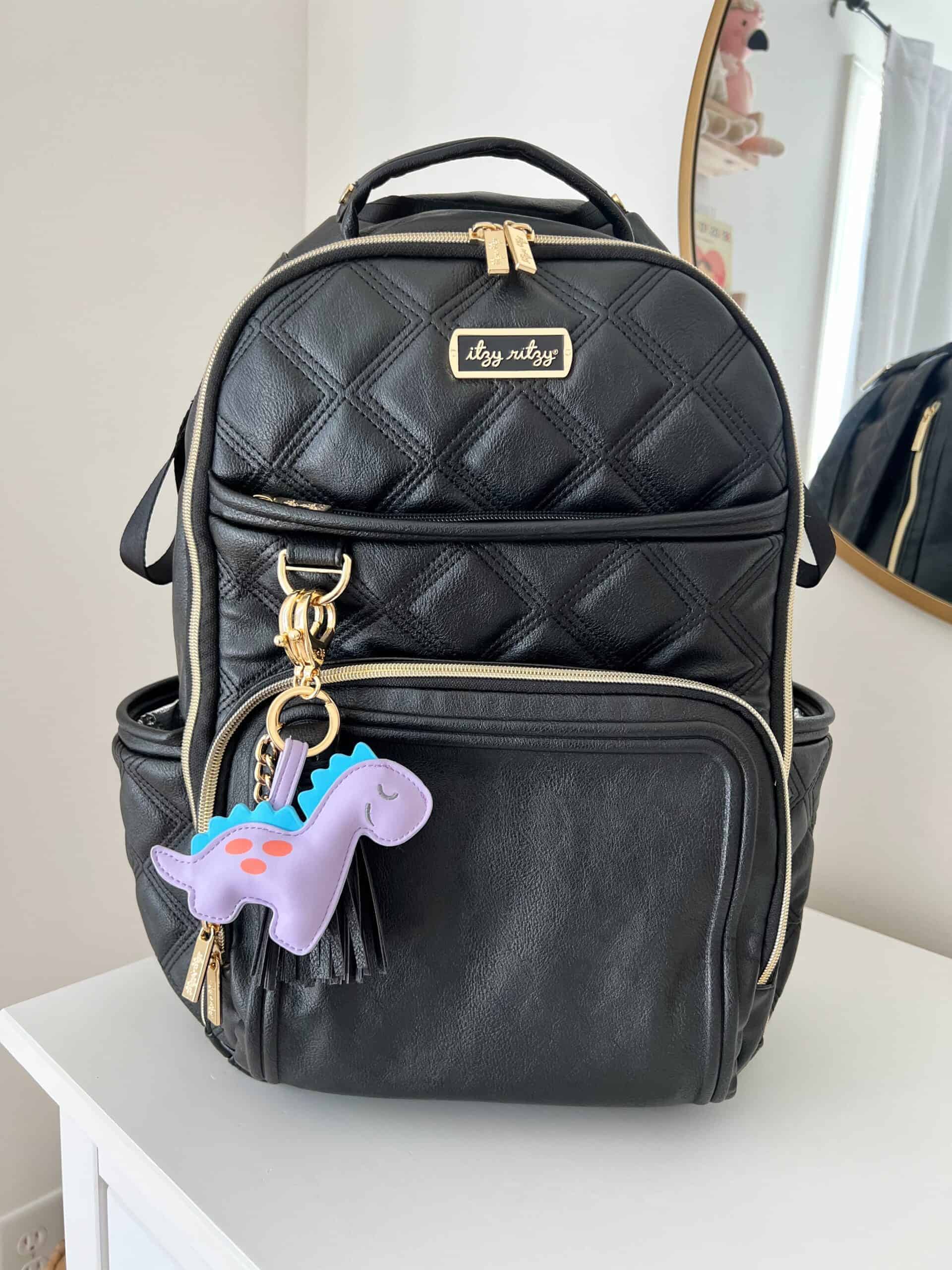 Itzy-Ritzy-Diaper-Bag-Accessories-CKP8430-Puffy-Charm-Lilac-Dino-scaled