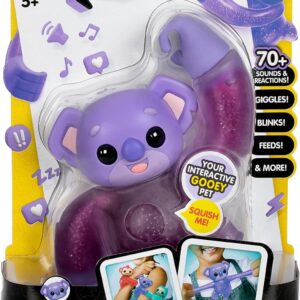 A packaged toy labeled "Hug n' Hang Zoogooz!" featuring a purple koala named Koomi Koala. It advertises over 70 sounds and reactions, including giggles and blinks. Suitable for ages 5 and up.