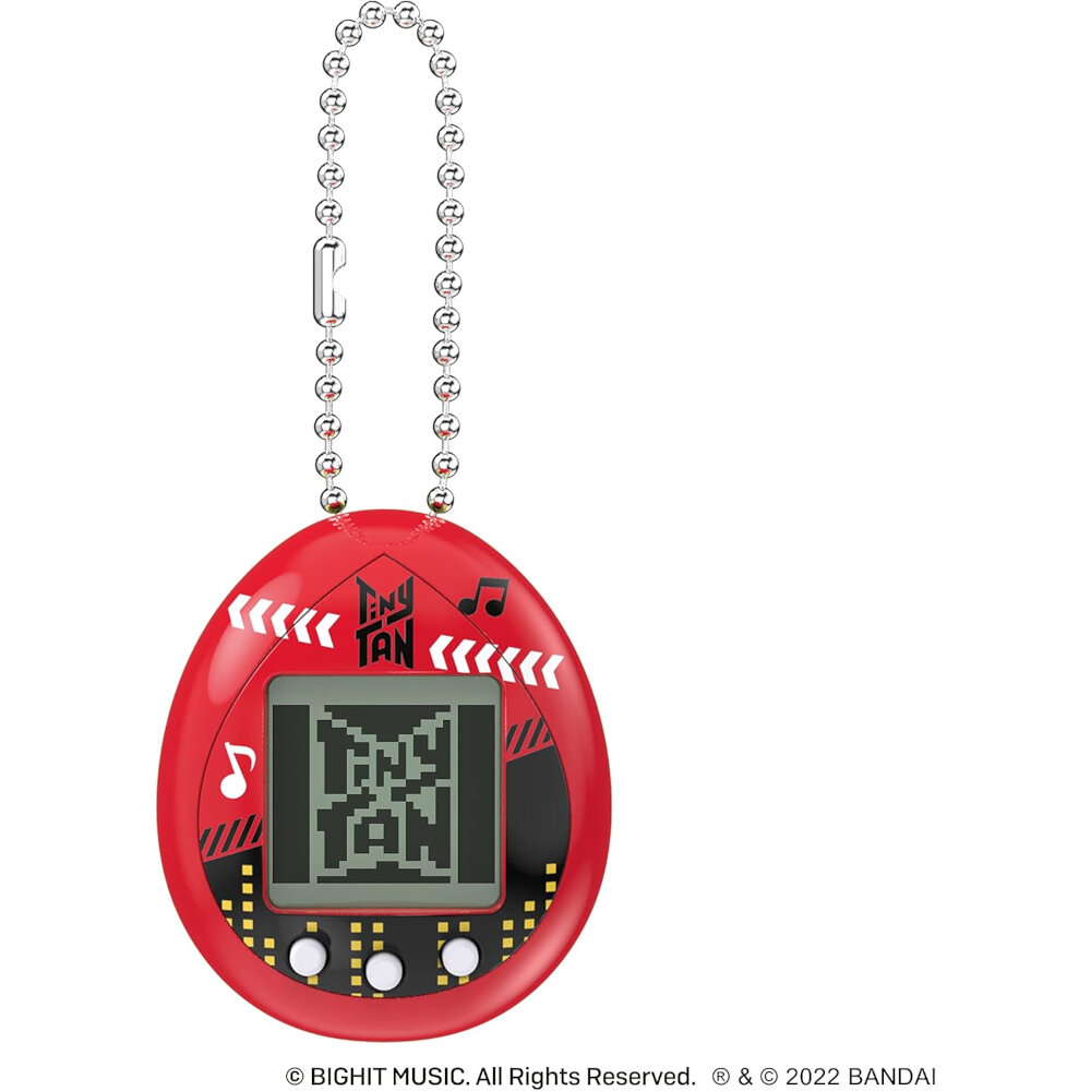 A red electronic keychain toy with a pixelated screen display, musical note designs, and a small chain looped at the top. Text at the bottom reads "© BIGHIT MUSIC. All Rights Reserved. & © 2022 BANDAI.