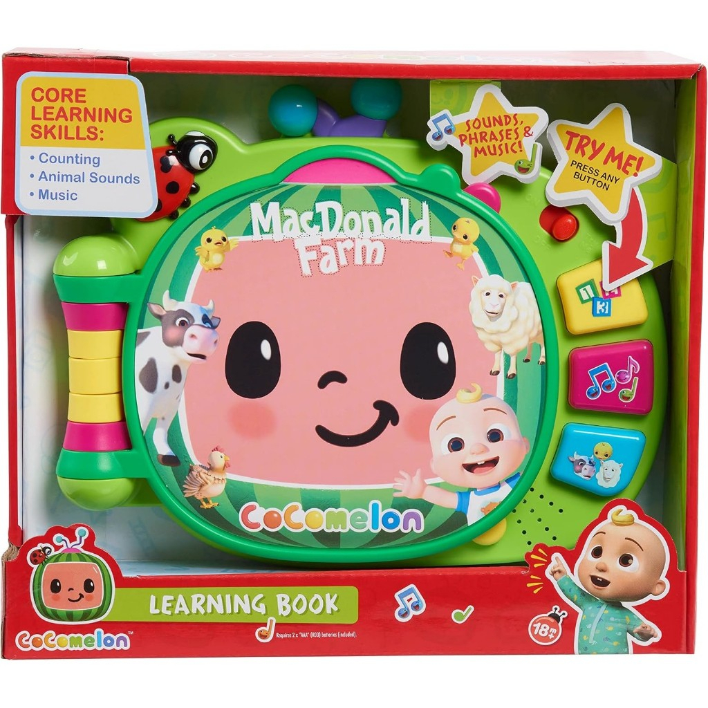 cocomelon-learningbook-107 CoComelon Learning Book Interactive Toy in packaging, featuring a smiling face, animal images, and buttons for music, numbers, animal sounds, and phrases—offering 3 play modes by Just Play.