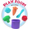 cocomelon-learningkitchen-75 A selection of plastic toy foods and utensils—including a muffin, carrot, spoon, broccoli, apple, and a purple pot—from the CoComelon Learning Kitchen 34 Piece Interactive Play Kitchen Letters Numbers Sounds Toddler Toy are arranged on a light blue background with the words “PLAY FOOD! INCLUDED.”.