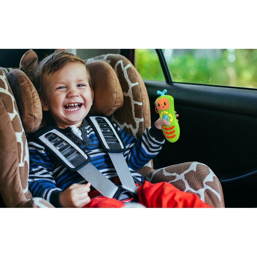 cocomelon-singingremote-70 A young child in a car seat smiles and holds the CoComelon Learn and Play Singing Remote Toddler Musical Toy Microphone, which lights up and plays nursery songs, inside a vehicle.