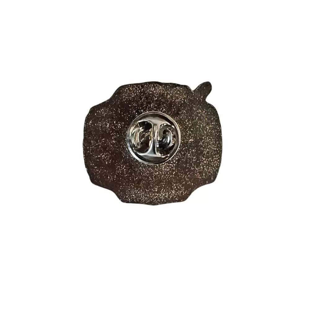digimon-adventure-digivice-enamel-pin-taichi (3) Close-up of the Digimon Adventure Digivice Enamel Pin Hard Taichi Tribute Custom Fan Fanbase, showcasing its round, textured, dark brown design with a shiny silver oval center and two circular attachments.