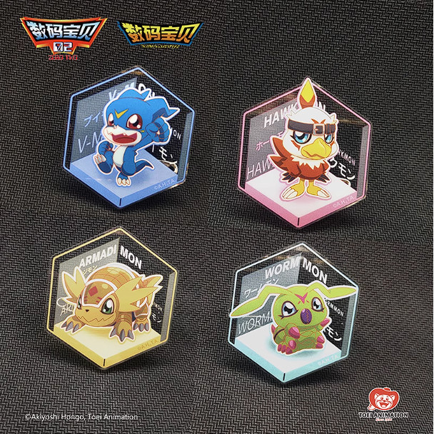 Four hexagonal acrylic badge stands from the “Digimon Adventure Digital Monster Toei Animation” collection feature cartoon Digimon: a blue wolf, a red bird, a tan armadillo, and a green worm, each on distinctively colored backgrounds with character names displayed.