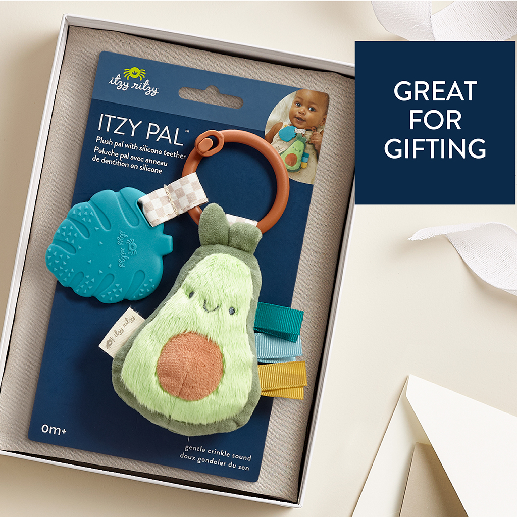 231220_Itzy_Ritzy_Digital_Shelf_ItzyPalAvocado A Itzy Ritzy - Itzy Pal - Plush Pal Infant Toy with Silicone Teether in a gift box with a label that reads "itzy pal," featuring a plush avocado and accessories. text on the image says "great for gifting.