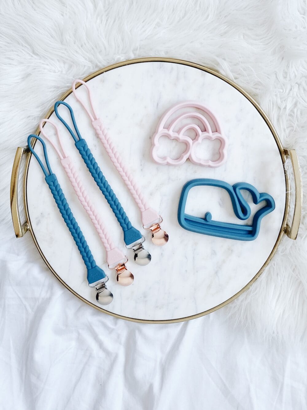 A tray with blue, pink, and white items on it.