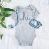 A baby's bodysuit with the word hi on it.