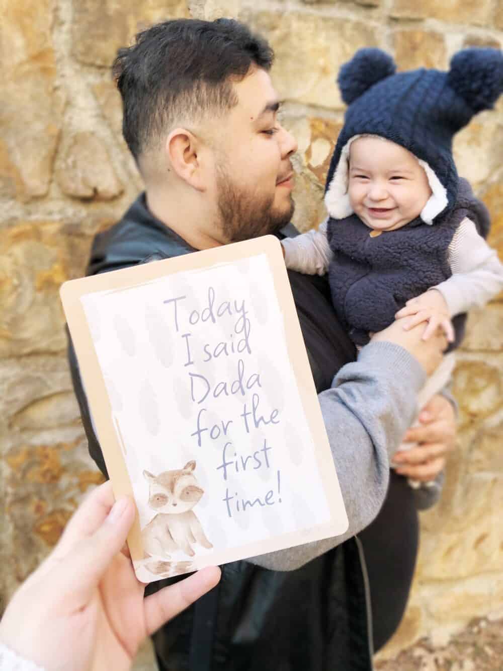 A man holding up a card that says today i'm daddy for the first time.