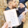 A man holding up a card that says today i'm daddy for the first time.