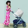 A woman in a floral dress pushing a Mom Boss™ 4-IN-1 Multi-Use Nursing Cover & Scarf.