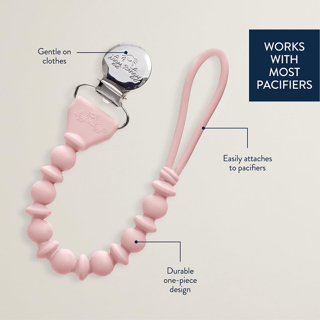 Pink silicone pacifier clip with beaded design and a metal clip. Features include being gentle on clothes, easily attaching to pacifiers, and having a durable one-piece design. Text: "WORKS WITH MOST PACIFIERS.