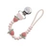 itzy-strap-plus-strawberry-03 Pink silicone pacifier clip with a beaded design featuring strawberries, a loop at one end, and a metal clip at the other end.