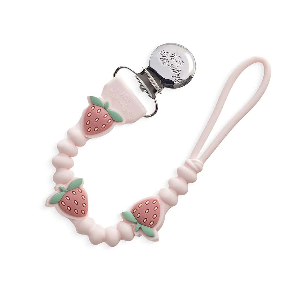 itzy-strap-plus-strawberry-03 Pink silicone pacifier clip with a beaded design featuring strawberries, a loop at one end, and a metal clip at the other end.