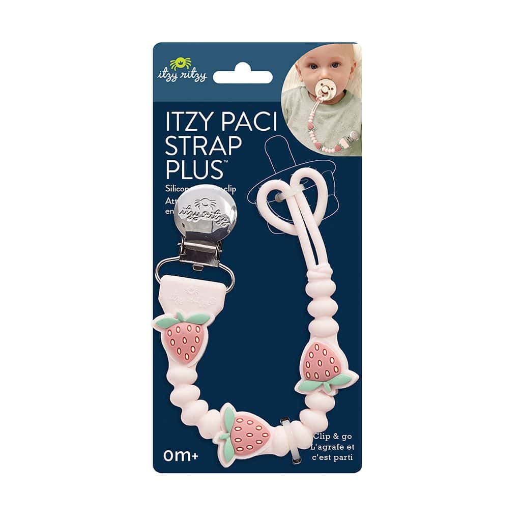 itzy-strap-plus-strawberry-05 Pink strawberry silicone pacifier strap with metal clip, shown in retail packaging. Package includes photo of baby using the product. Suitable for newborns and up.