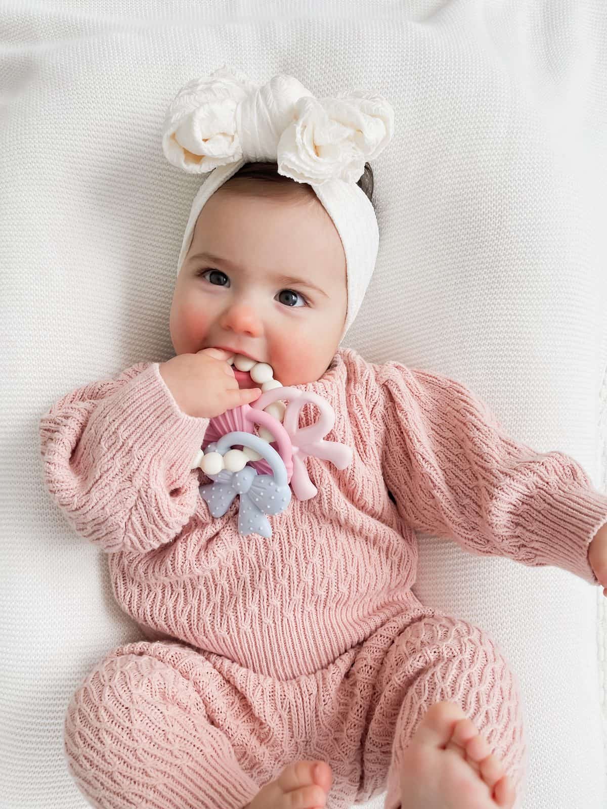 Itzy Ritzy Itzy Trio silicone teether Bows Itzy Ritzy Itzy Trio multi textured silicone teether in the Bows style