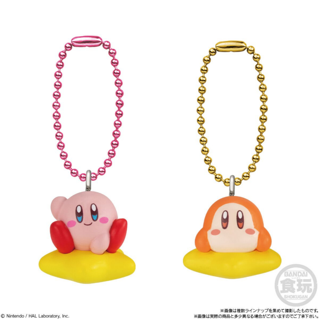 kirby-shokugan-3 Two keychains from the Kirby Mascot Shokugan Wave 1 Box Keychain Collection, featuring Kirby and Waddle Dee sitting on yellow stars, each attached to a beaded chain—one pink and one gold.