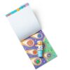 melissadoug-stickerwow-2 A Melissa & Doug Sticker WOW Activity Pad is open, showing its blank white pages, a vibrant space-themed sheet, and a small astronaut marker resting on top.