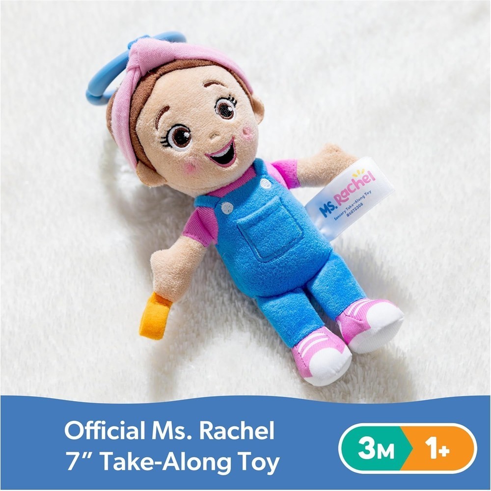 Ms Rachel Official Sensory Take-Along Toy Herbie Doll, a 7-inch plush doll featuring blue overalls and a pink shirt, designed as a baby teether and rattle with stroller clip, suitable for ages 3 months and up.