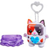 nanomals-112 A Hasbro Nano mals Purrnelope Calico Kitty Electronic Pet Interactive Fidget Toy shaped like a small, colorful cat with a heart-shaped light on its chest, pictured next to a purple skirt-like accessory.