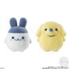 tamagotchi-frienddoll-5 Two round plush figures from the Bandai Tamagotchi Otomodachi Friend Doll Flocked Figure collection are shown: one resembles Mametchi, white with blue bunny-like ears, and the other resembles Kuchipatchi, yellow with floppy ears and a blue nose.