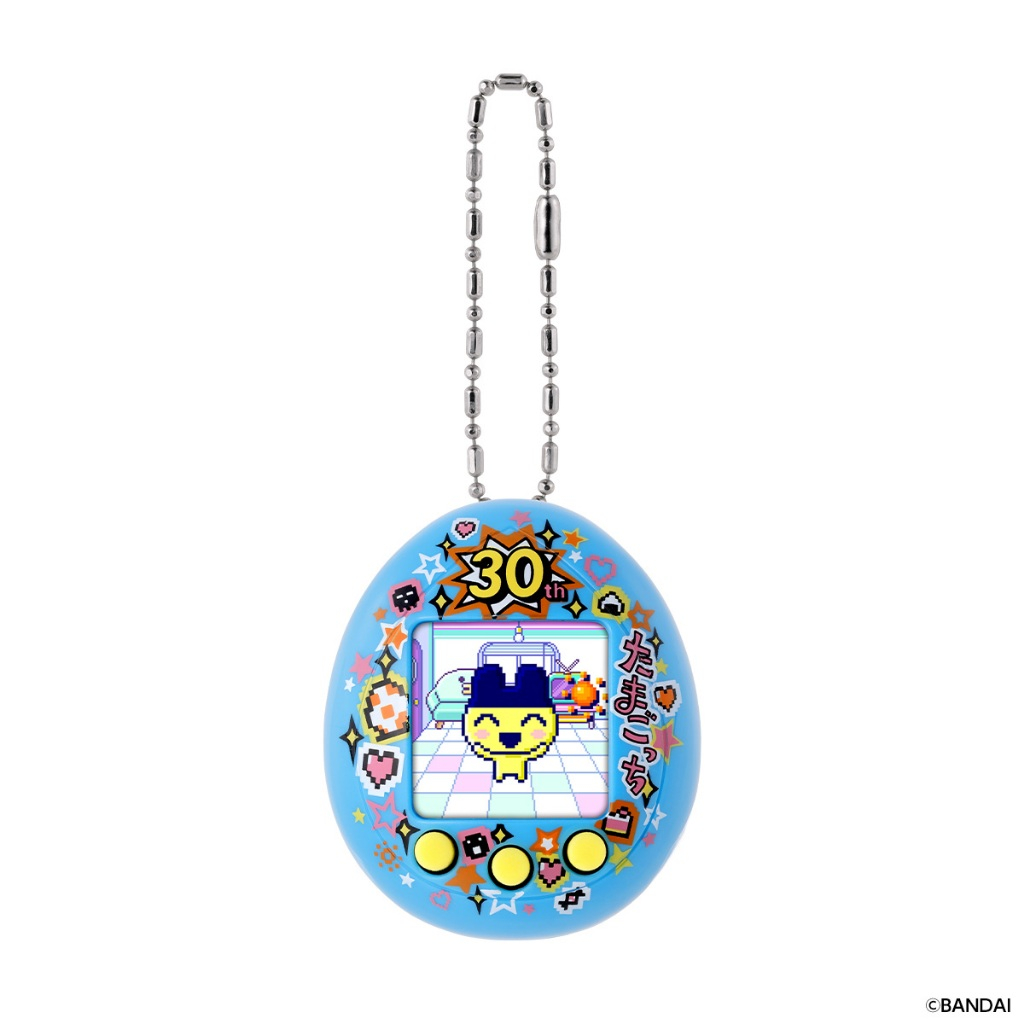 tamagotchi-nanocolorful-mametchimemories-126 A Bandai Tamagotchi Nano Colorful Mametchi Memories 30th Anniversary Yellow Blue Vpet Virtual Pet featuring a character on the digital screen, decorated with stars and hearts, and equipped with a metallic keychain at the top.